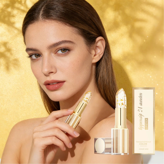 Woman holding the luxury gold foil color-changing lipstick next to its premium gold packaging.