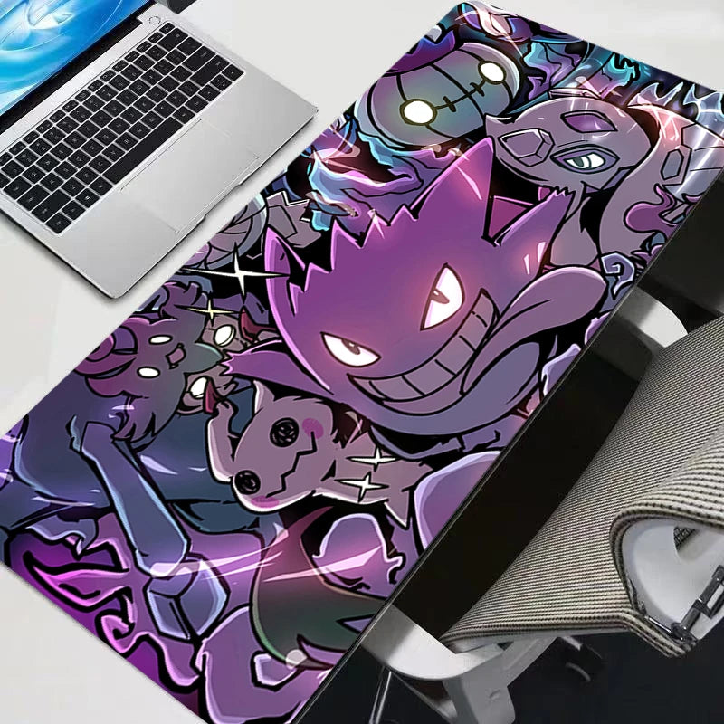 Vibrant purple Gengar and ghost-type Pokémon XXL gaming mouse pad on a modern desk with a laptop and chair.