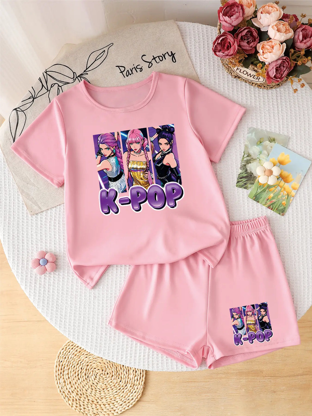 Pink 2-piece girls' summer set with a "K-POP" girl group graphic print on the shirt and shorts.