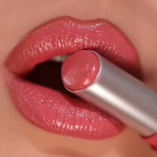 Close-up of a person applying the watery mirror gloss lipstick showing the ultra-hydrating and reflective glass finish.
