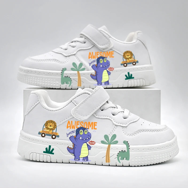 Pair of white children's sneakers featuring colorful dinosaur and lion cartoon prints with a velcro strap.