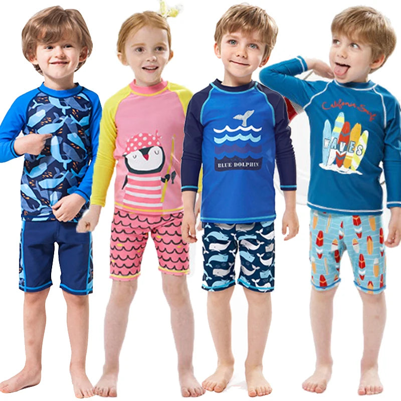 Four kids wearing different 2-piece long-sleeve swimsuit sets with shark, penguin, and surf designs.
