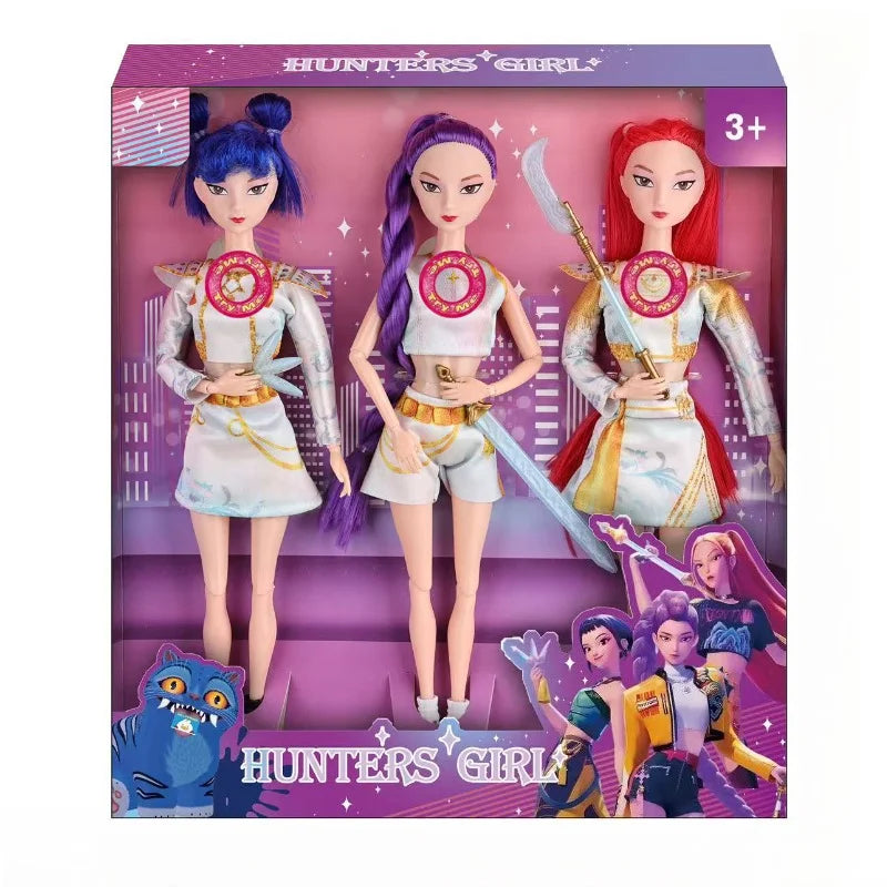 Sealed Bandai box pack featuring three 11.5-inch K-Pop Demon Hunters dolls with light-up musical buttons and stage weapons.