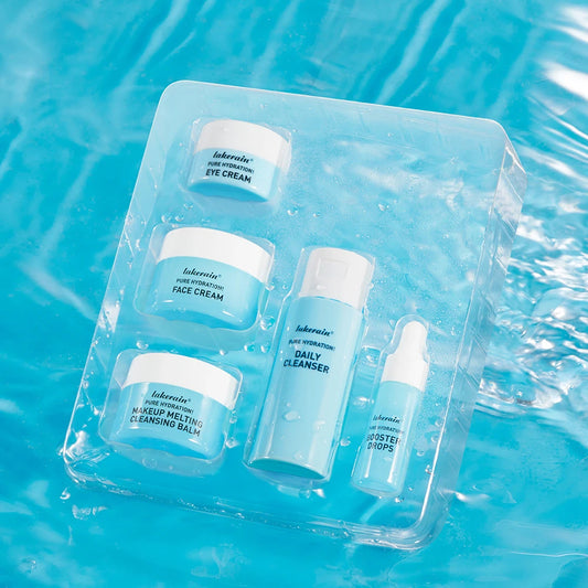 The 5-piece lakerain Pure Hydration mini kit including cleansing balm and booster drops over a water splash background.