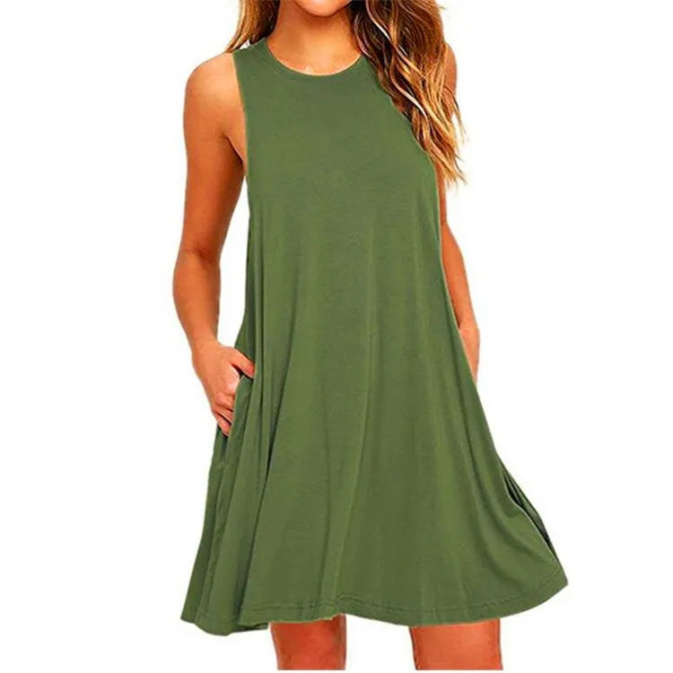 Woman wearing a green sleeveless summer swing t-shirt dress with side pockets on a white background.